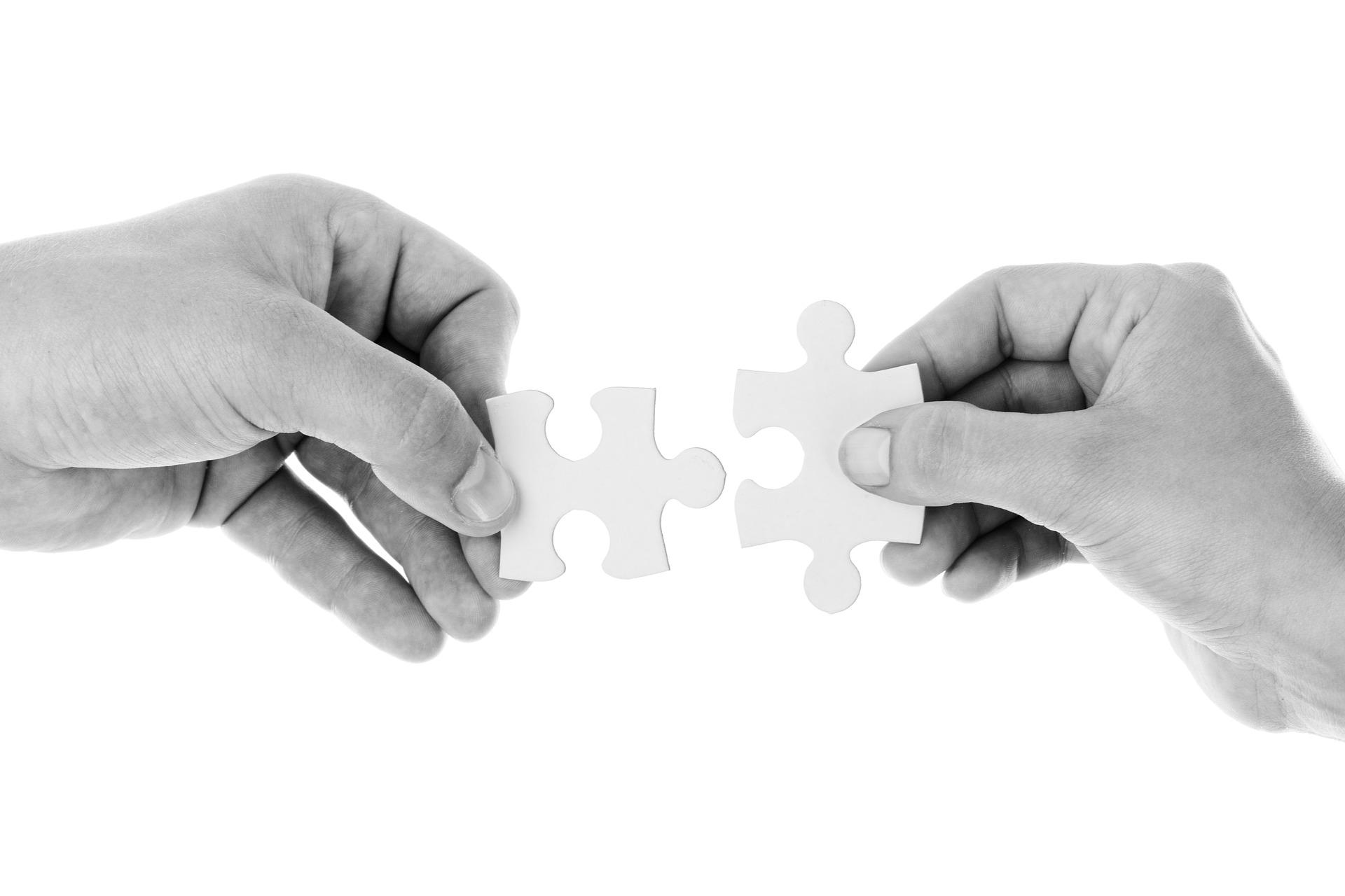 two hands connecting puzzle